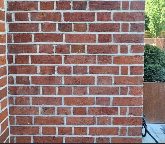 Image taken of a red brick wall, which has been repointed.