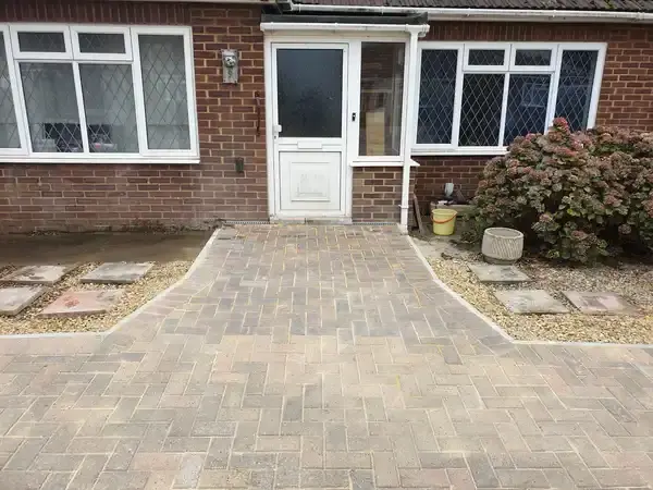 image of front house with new driveway of single bricks leading from the house doorway to the edges of the garden, laid with bricks rather than patio slabs.