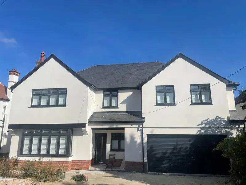 Image of large white house, that we did a garage extension.