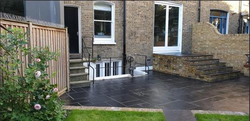 image of back garden with new black tiled patio