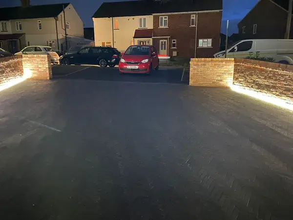 New garden patio, laid with black flooring. New wall on the left and right outside front garden with added electric lights to enhave appearance.