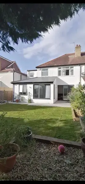 image of a white coloured new house back garden extension, walls plastered and painted white to match exterior of house